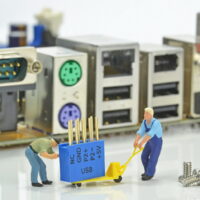 Computer repairs concept with mini figures and components